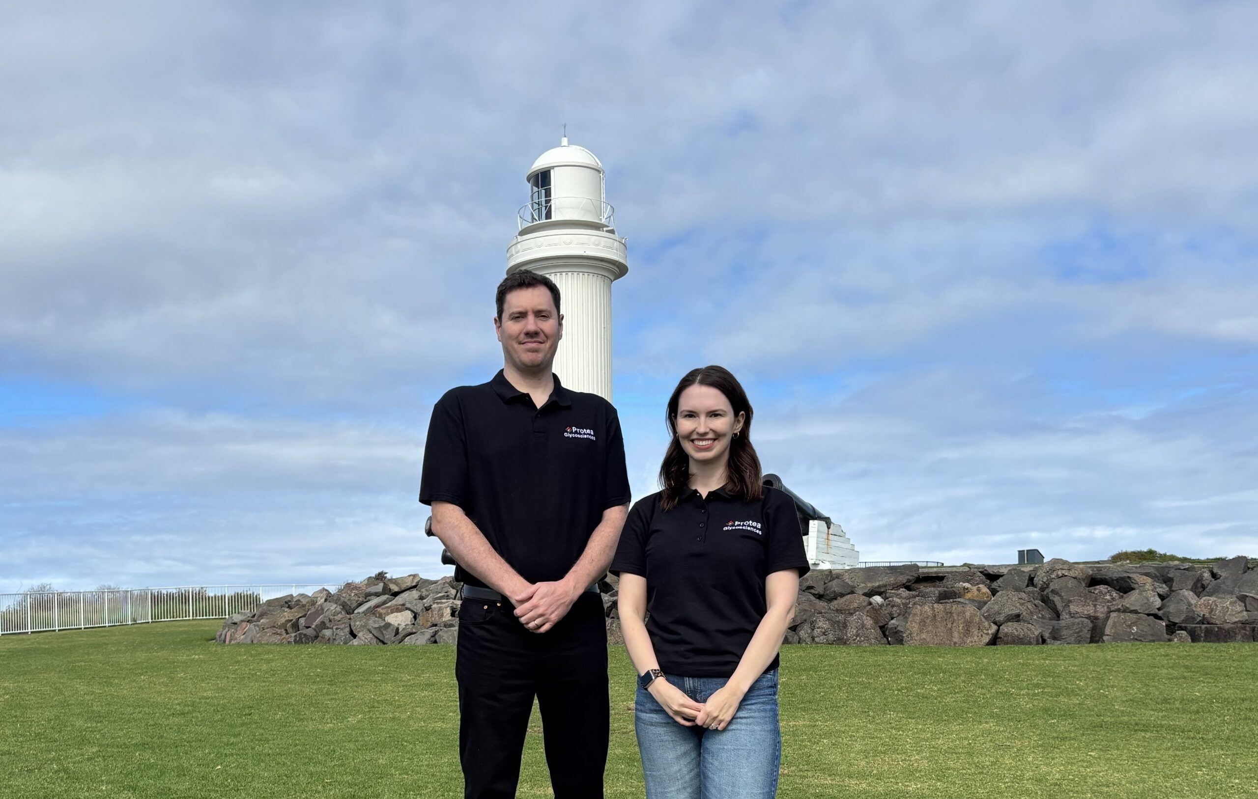 Christopher Ashwood and Maia Kelly wearing Protea Glycosciences shirts outdoors.